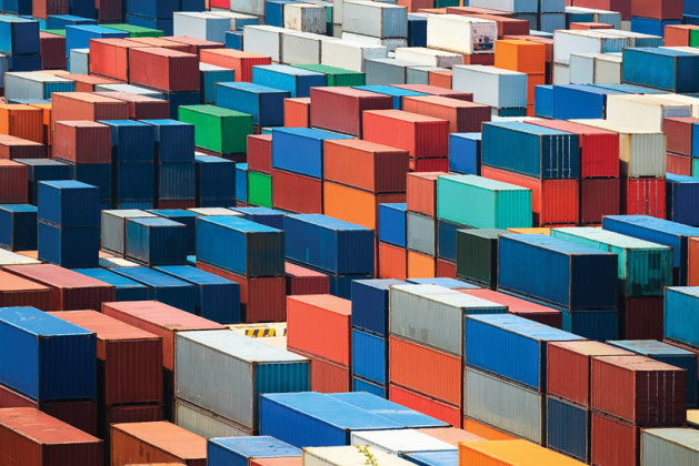 Dense stacks of red, blue, orange, green and white shipping containers.