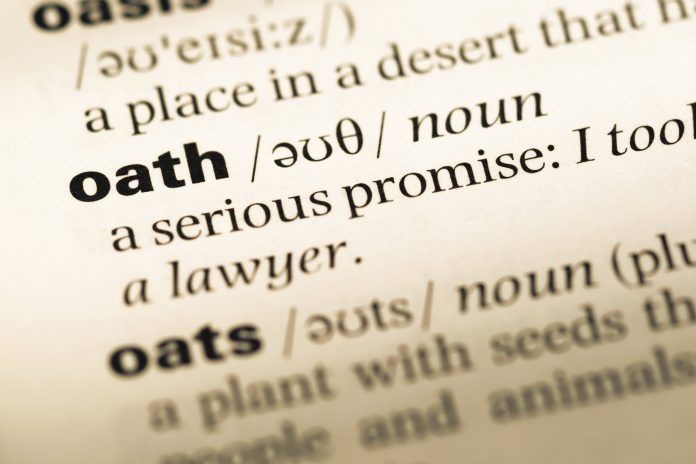 Close-up of a dictionary entry for oath, defined as a serious promise.