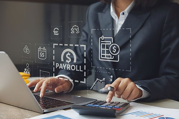 A person uses a laptop and calculator with payroll and finance icons overlaid.