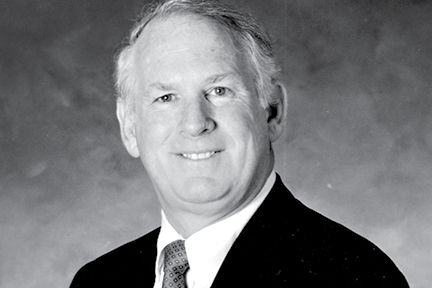 Black-and-white portrait of Wilford D. Godbold in a suit and tie.