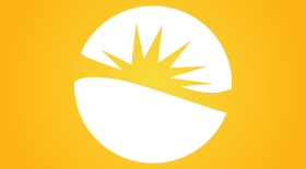 A white circular emblem split by a yellow sunburst on an orange background.