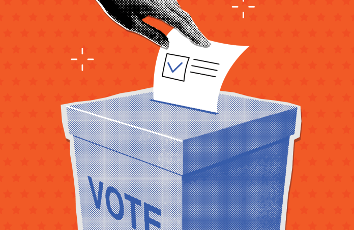 Hand dropping a ballot with a checkmark into a voting box labeled 'VOTE'.