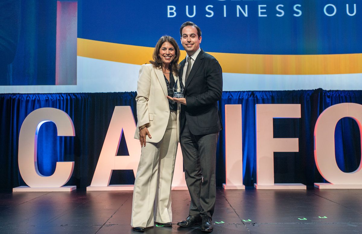 Maryam S. Brown, 2025 CalChamber chair, presents the Chamber of the Year Award to Evan Sanford, executive director of the Redlands Chamber of Commerce.