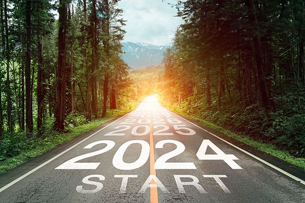 A forest road marked 2024 Start leads toward sunlight, with later years receding ahead.