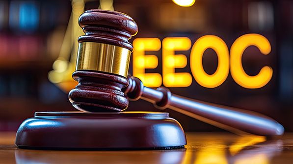 A wooden gavel and block in front of glowing EEOC lettering.
