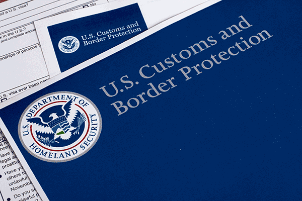 U.S. Customs and Border Protection booklet and paperwork with the Department of Homeland Security seal.