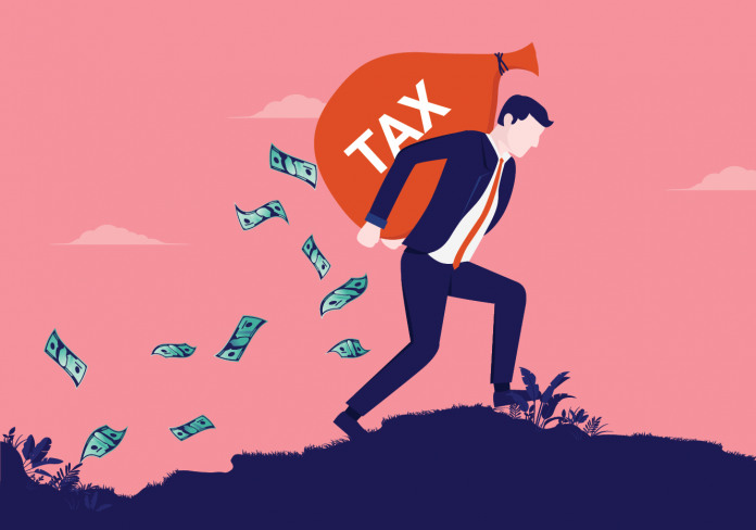 Illustration of a person climbing uphill with a large sack labeled TAX as banknotes trail behind.
