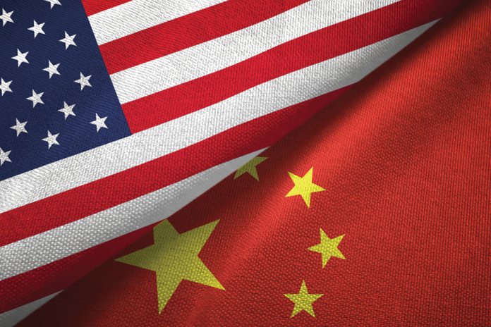 United States and China flags overlap in a close-up of textured fabric.