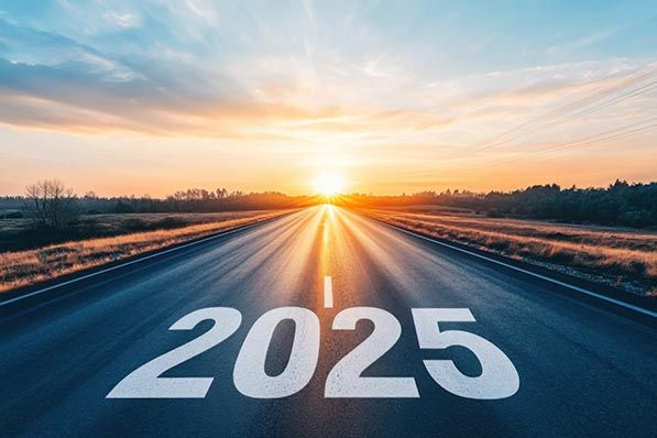 The number 2025 painted on a highway leading toward the sunrise.
