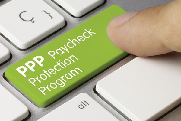 A finger presses a green keyboard key labeled PPP Paycheck Protection Program.