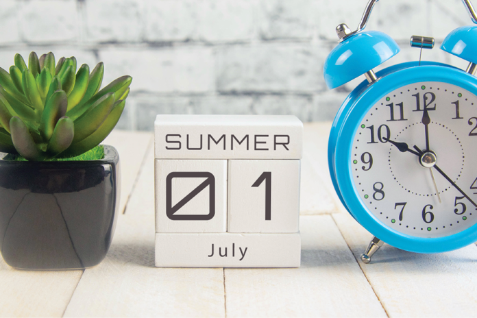 Calendar blocks reading Summer, July 01 beside a succulent and blue alarm clock.