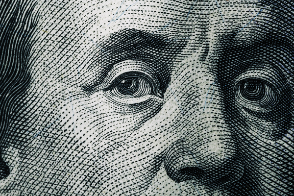 Extreme close-up of Benjamin Franklin's eyes on a United States banknote.