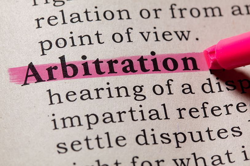 The word Arbitration is highlighted in pink in a printed dictionary-style passage.