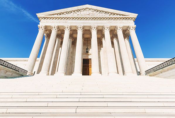 Front view of the U.S. Supreme Court's tall columns and wide white steps.