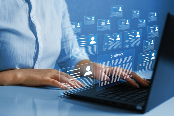A laptop user beneath overlaid digital identity cards and contract icons.