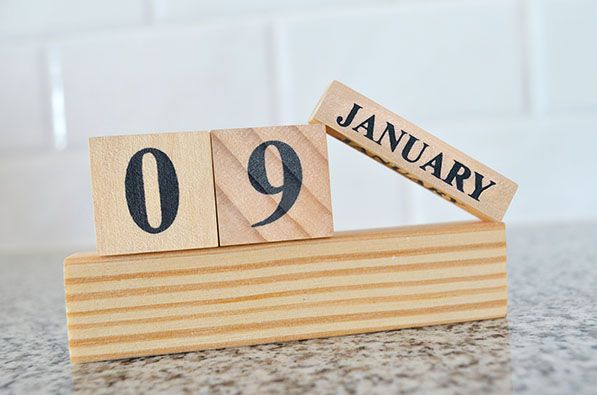 Wooden block desk calendar showing January 09.