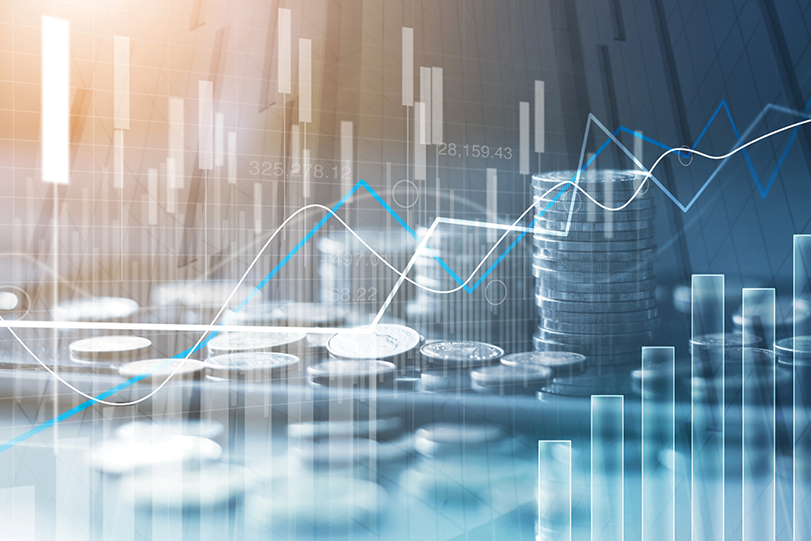 Stacks of coins overlaid with financial charts and upward trending lines.