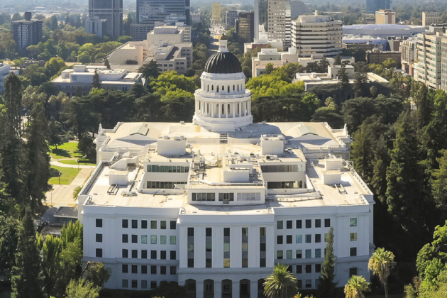 Aerial view of the California State Capitol and surrounding downtown buildings.