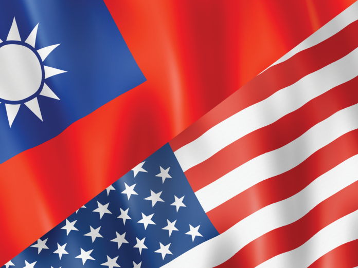 Taiwanese and U.S. flags overlap on rippling fabric.