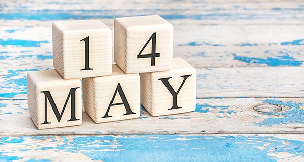 Wooden calendar blocks display May 14 on a weathered blue-and-white surface.