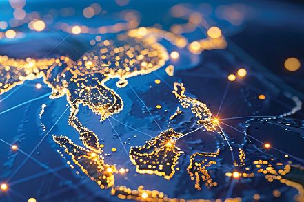 A digital map of Asia glows with gold lights and connected routes.