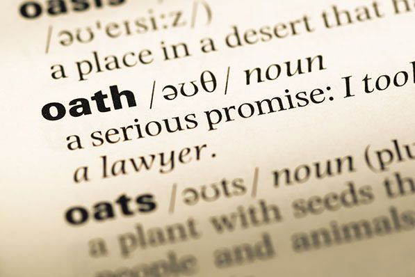 Close-up of the word oath and its definition on a dictionary page.