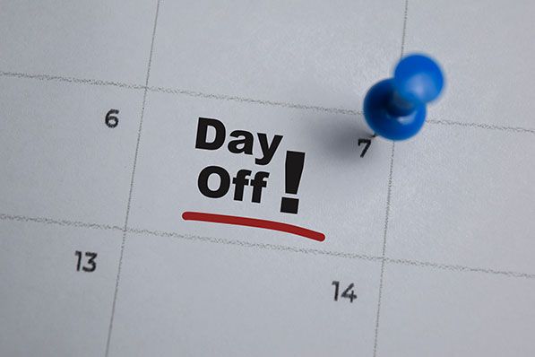 Calendar marked Day Off! with a blue pushpin.