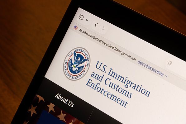 A tablet displays the U.S. Immigration and Customs Enforcement website.