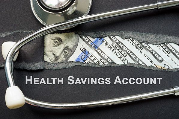 Dollar bills and a stethoscope surround the words HEALTH SAVINGS ACCOUNT.