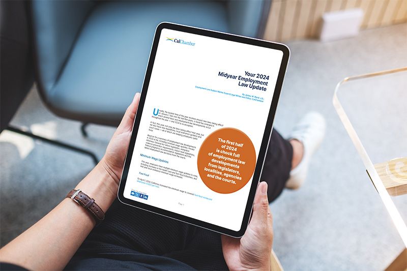 Hands hold a tablet displaying Your 2024 Midyear Employment Law Update from CalChamber.