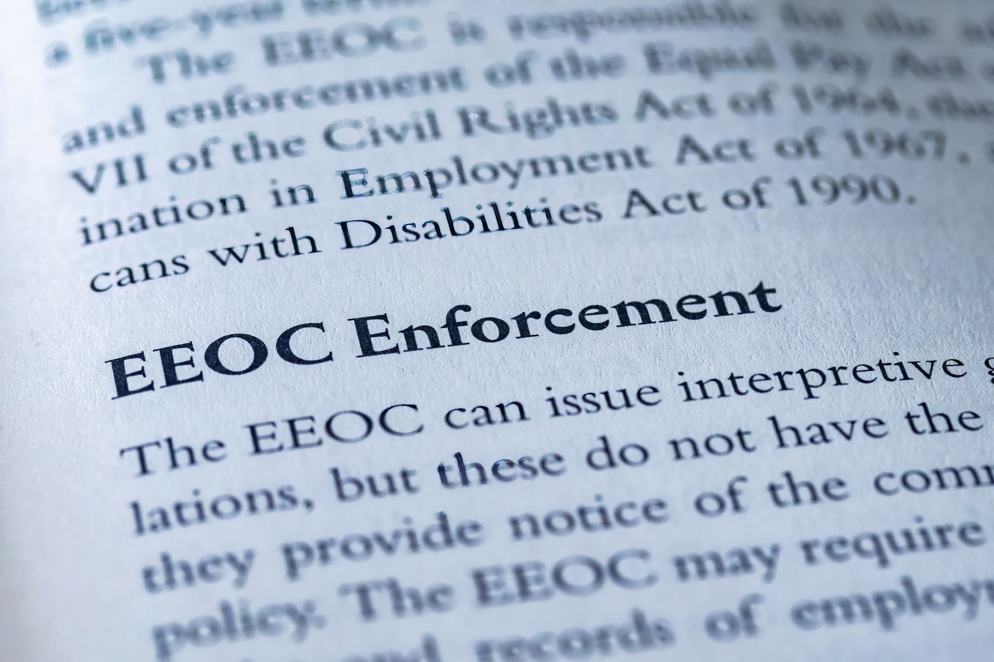 Close-up of a printed page headed EEOC Enforcement discussing employment laws.