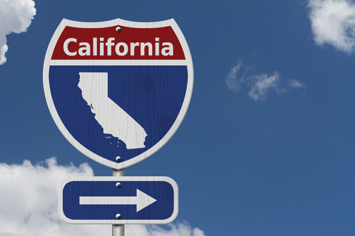 A California highway-style sign with a state silhouette above a right-pointing arrow.
