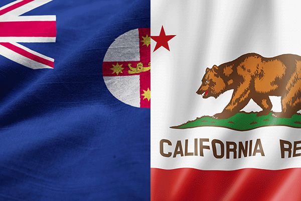 New South Wales and California flags displayed side by side on rippling fabric.