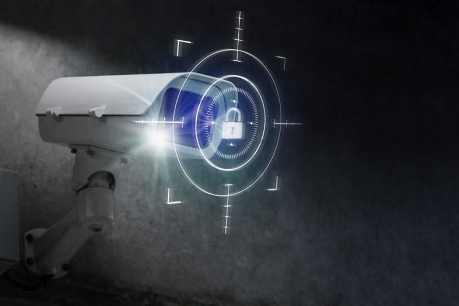 A CCTV camera on a dark background, overlaid with a padlock graphic