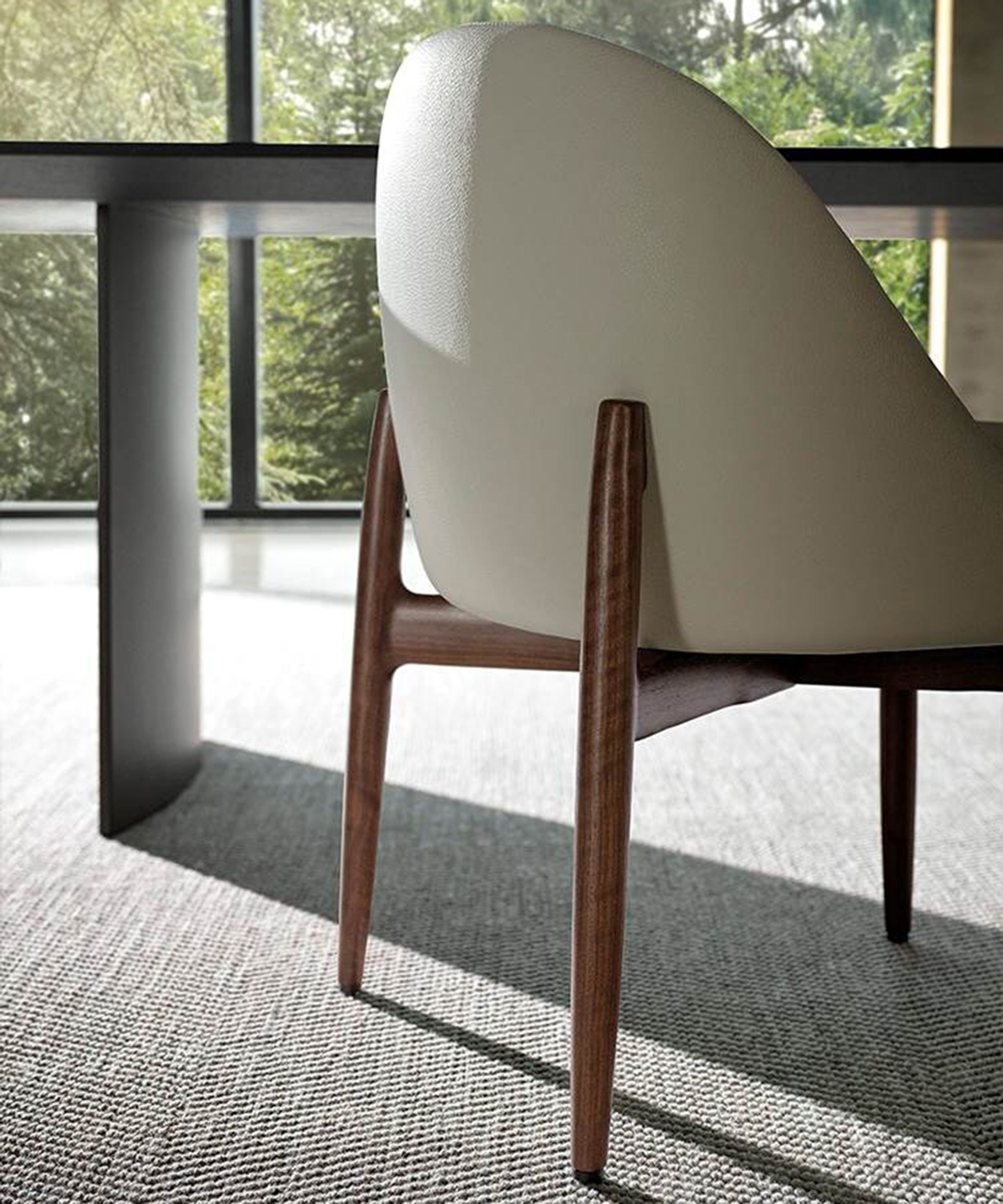 A sleek dining little armchair by Minotti.