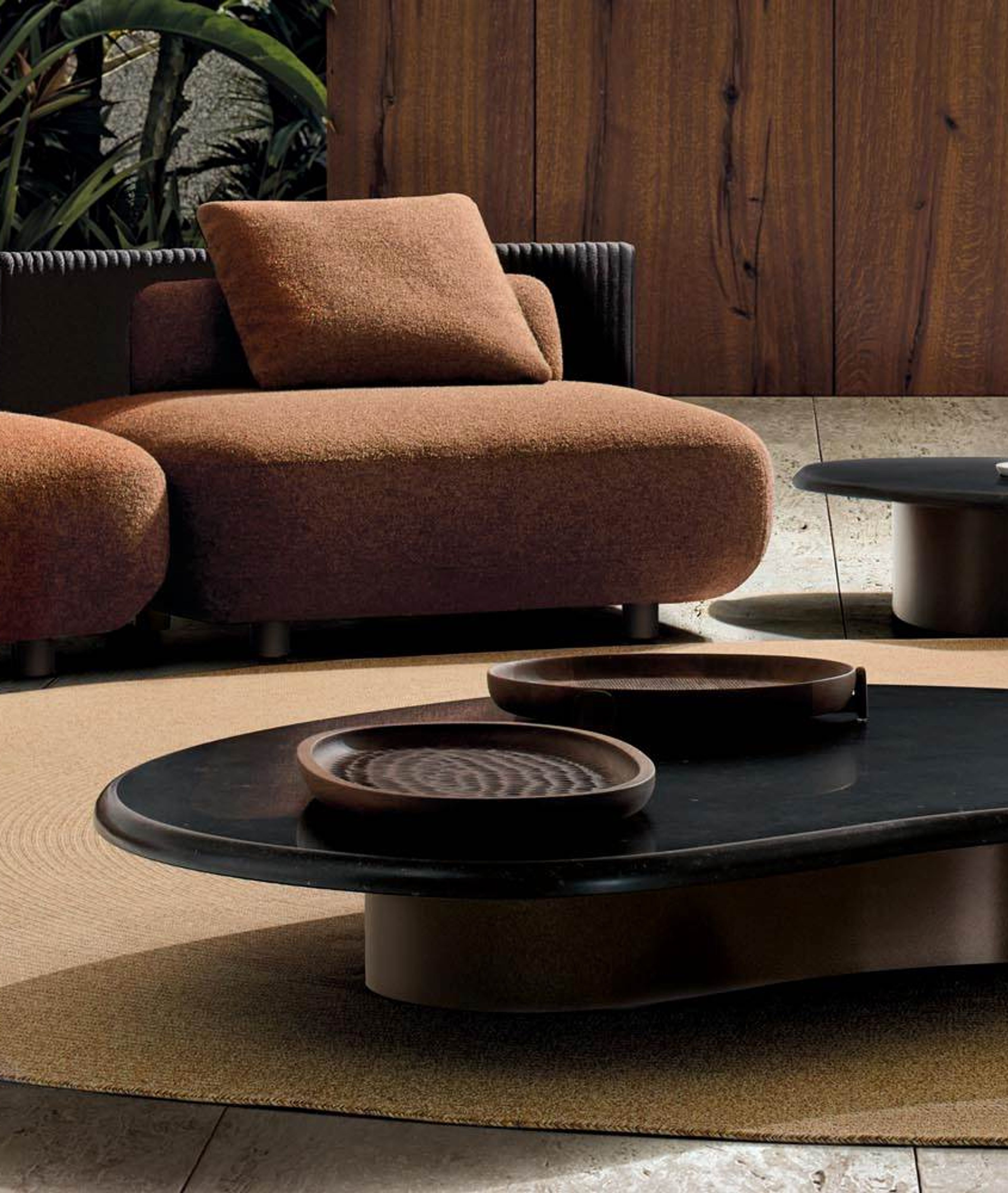Minotti`s Bézier Outdoor table defined by a fluid, continuous form.