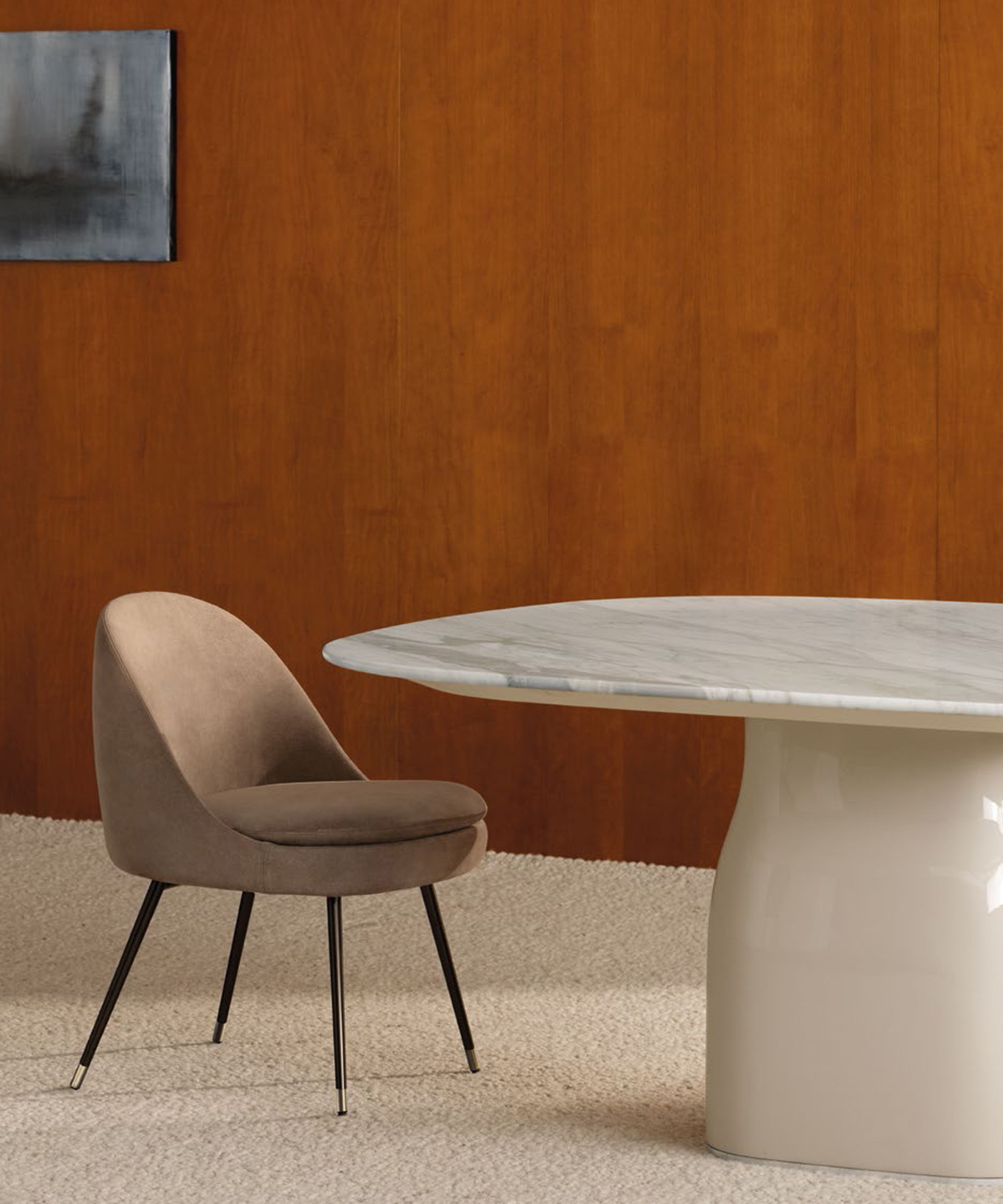 A sleek dining little armchair by Minotti.
