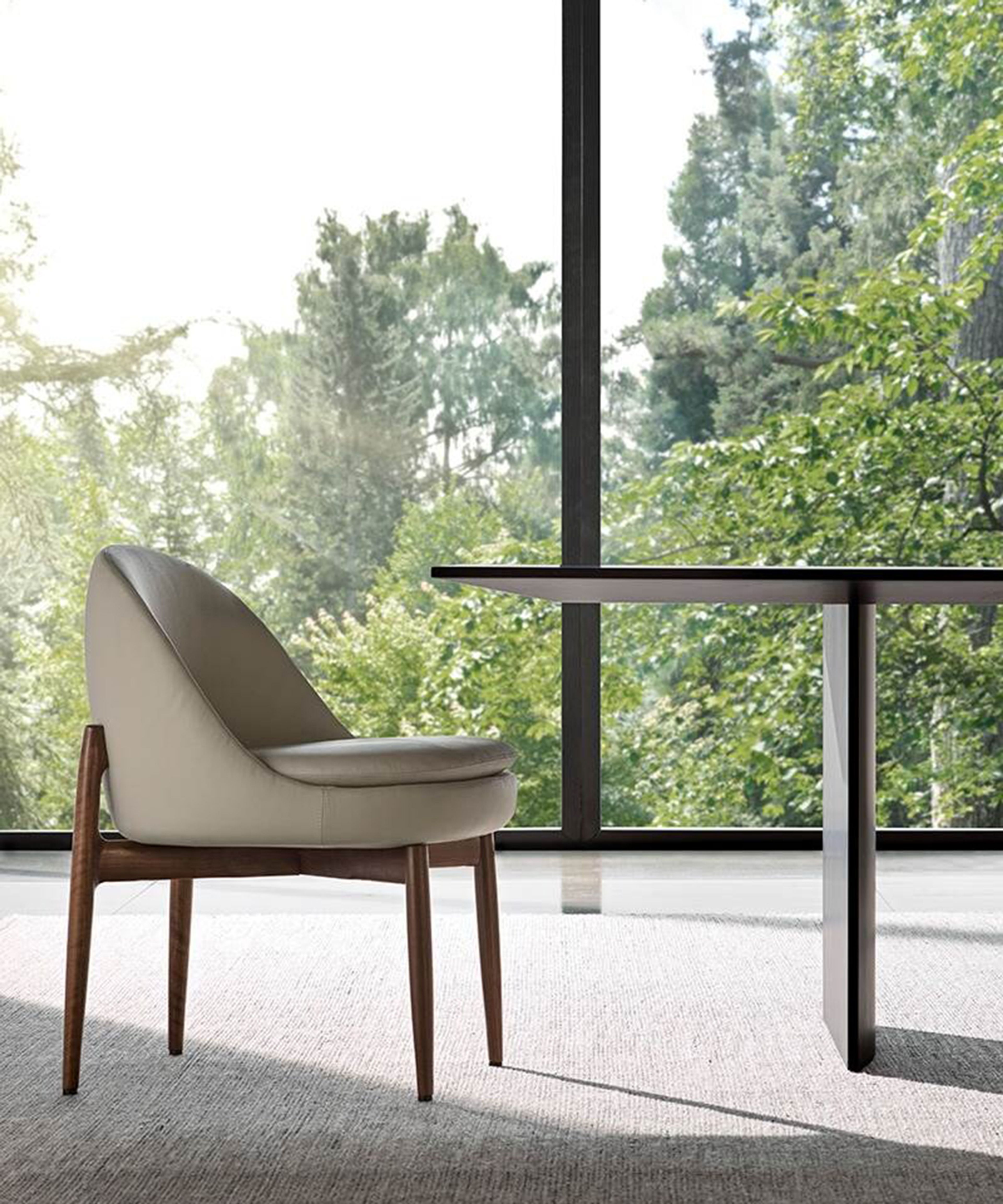 A sleek dining little armchair by Minotti.