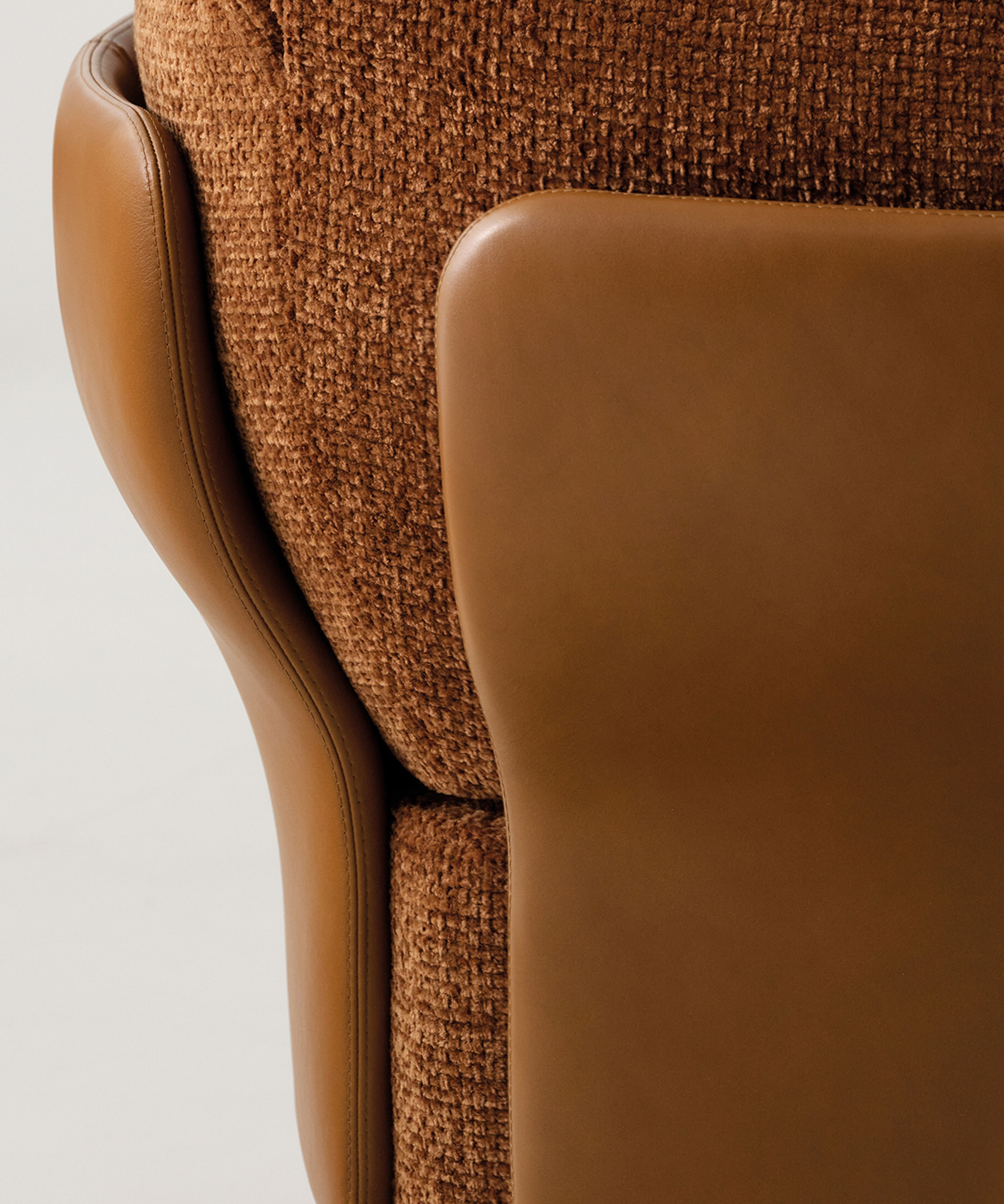 A sculptural armchair with enveloping organic forms by Minotti.