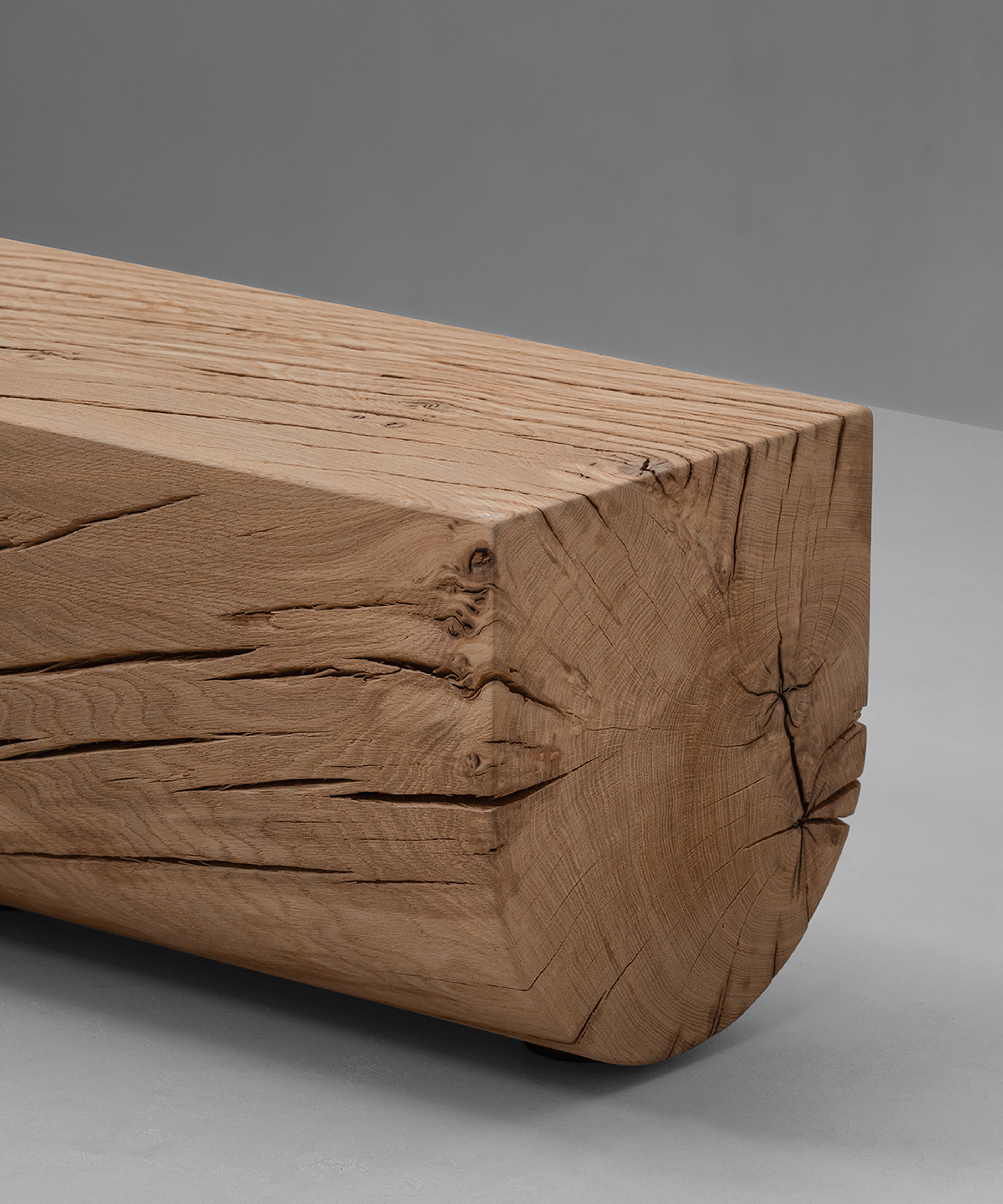 The Adjacencies Bench features a solid oak surface with a clear rectangular form.
