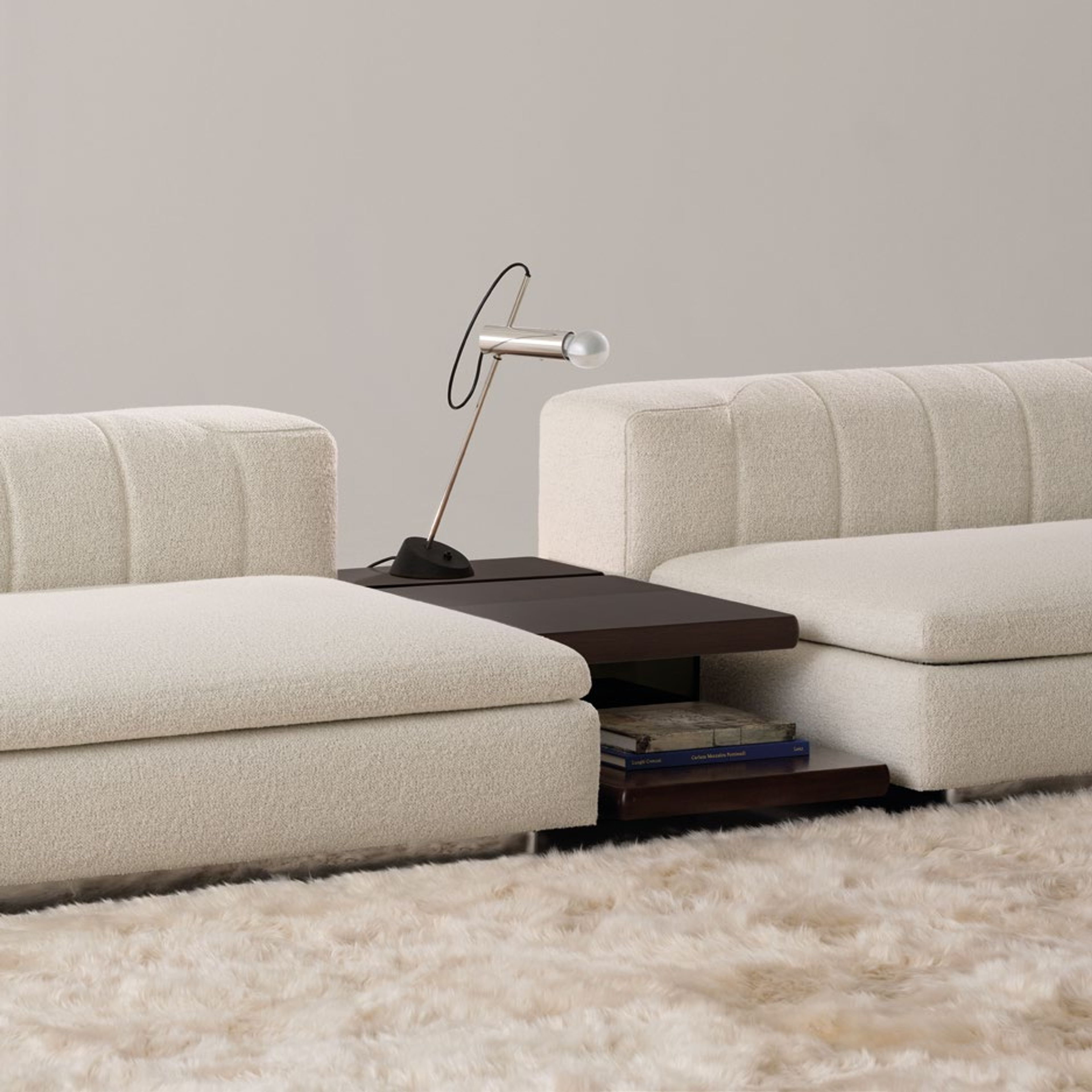 Minotti Coffee table defined by sharp geometric volumes.