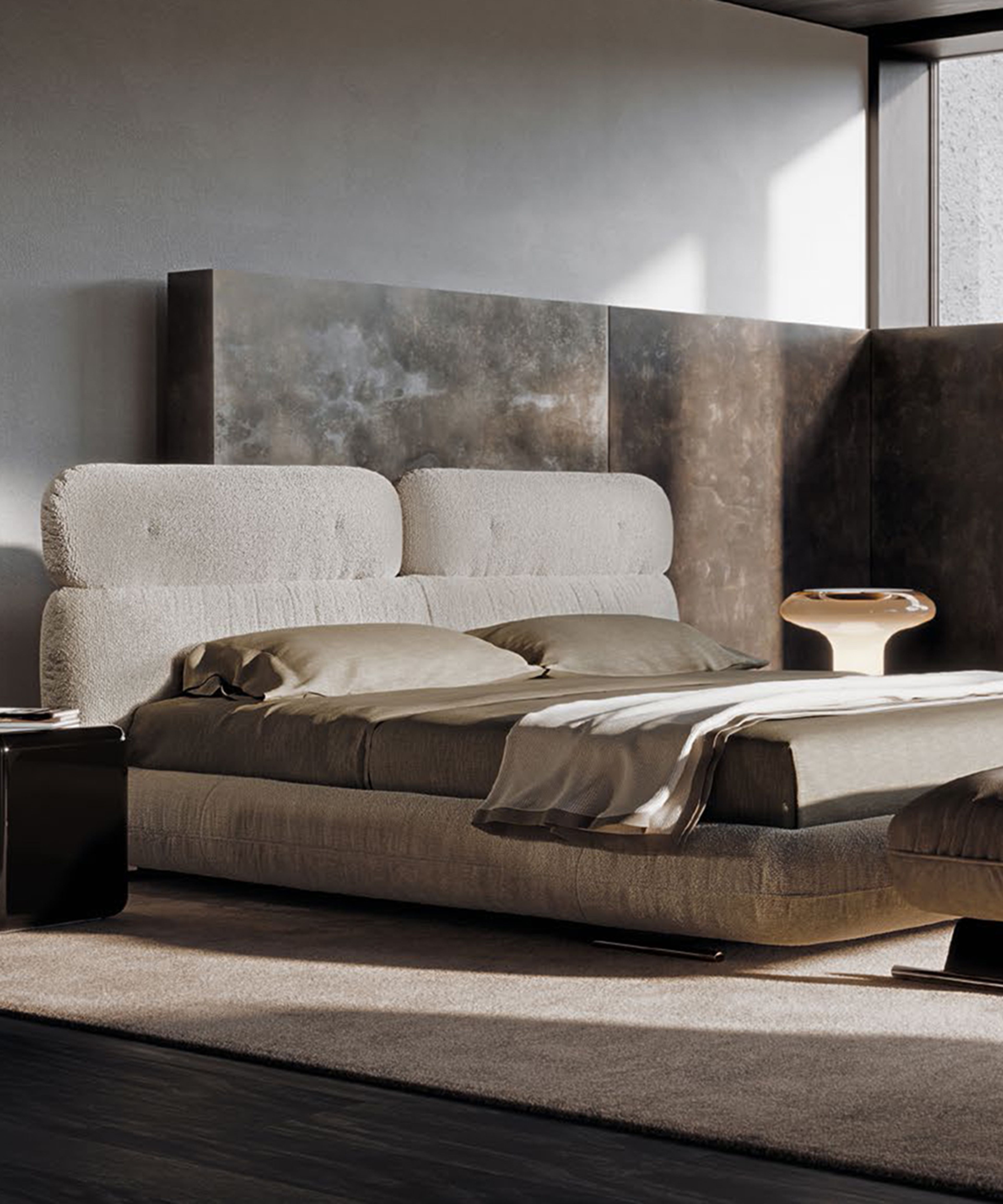 Libra bed by Minotti is defined by layered rounded volumes.