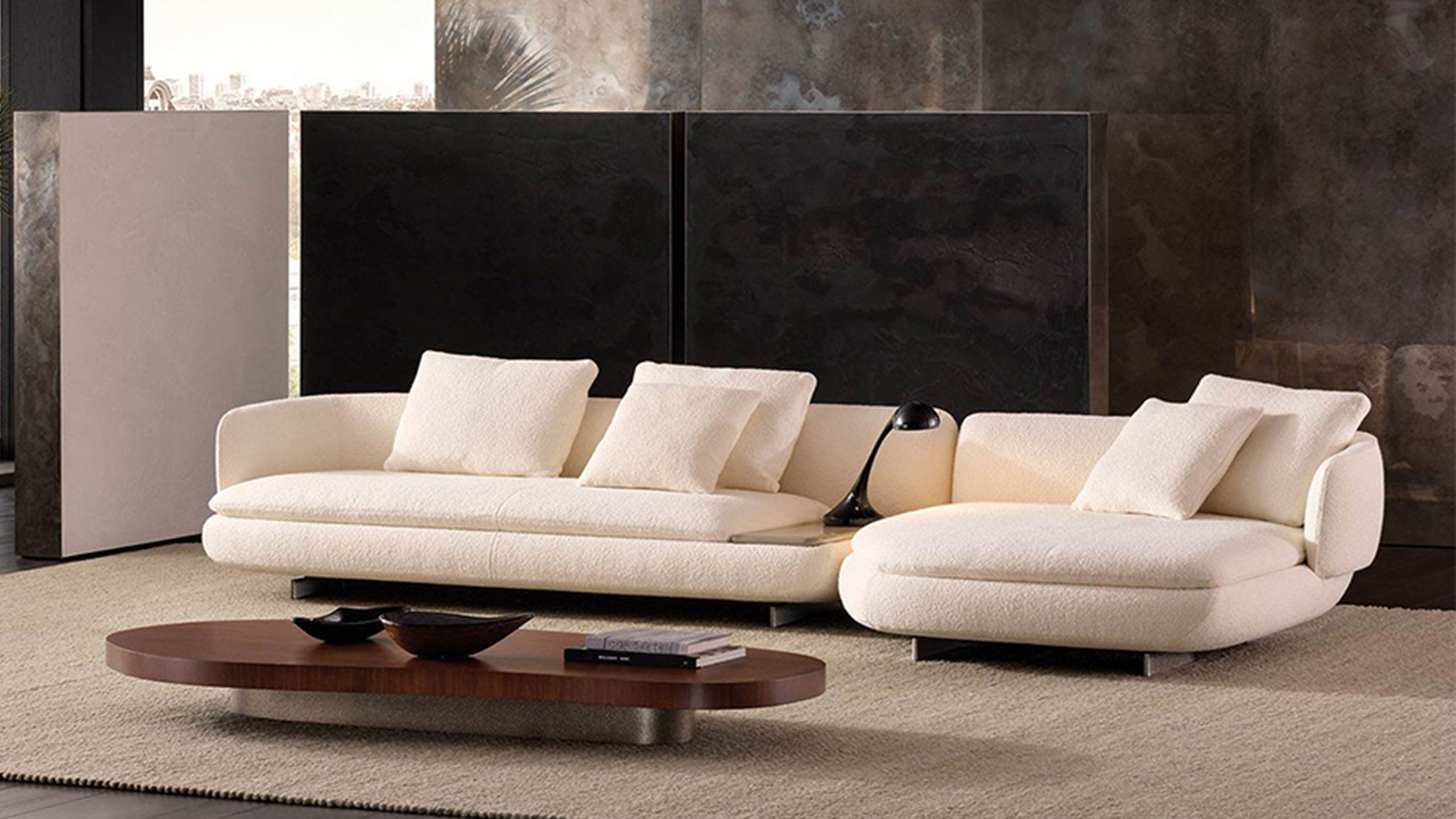 A fluid seating system by Minotti, where generous curves and geometric rigour meet in a light, decorative, and iconic design.