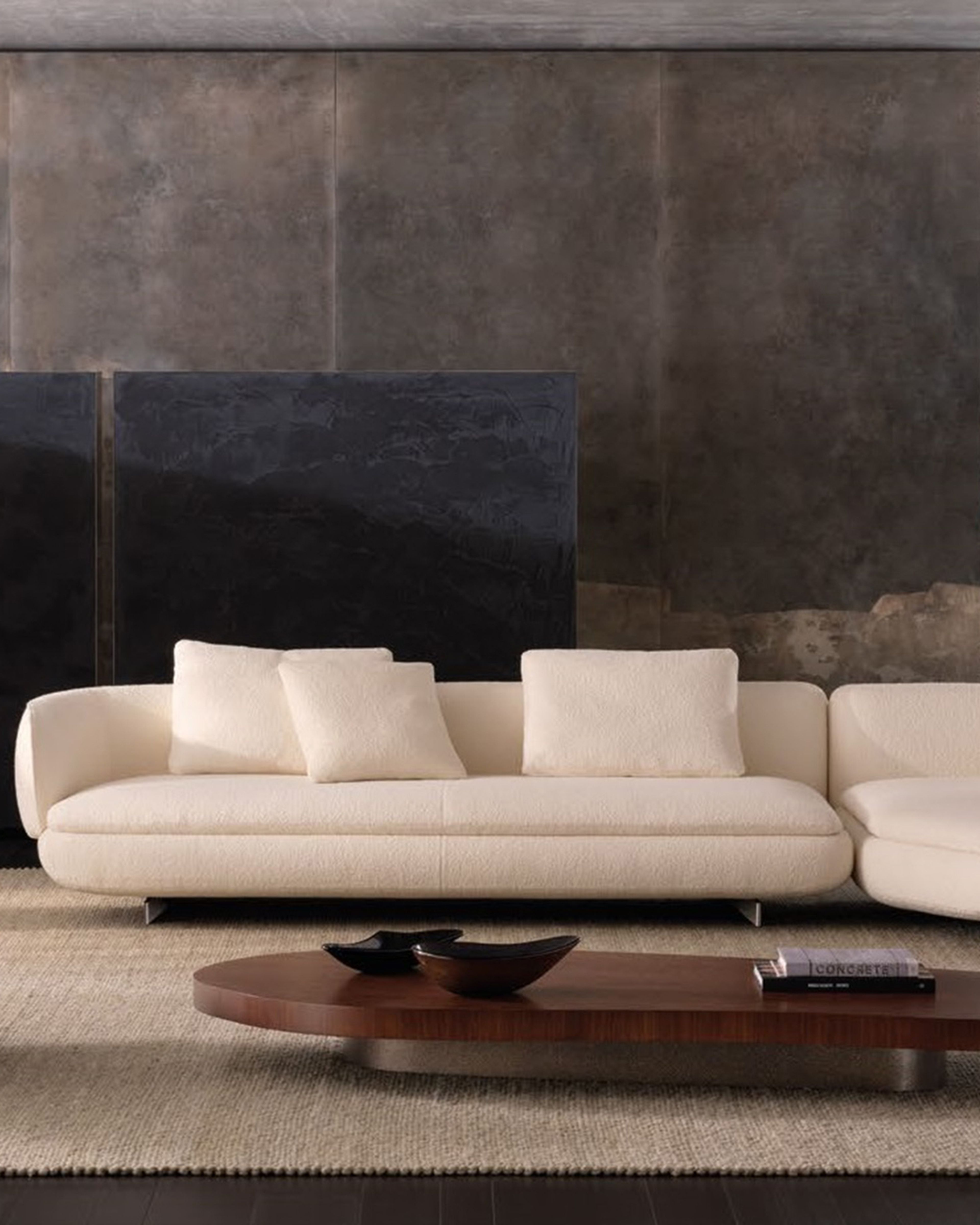 A fluid seating system by Minotti, where generous curves and geometric rigour meet in a light, decorative, and iconic design.