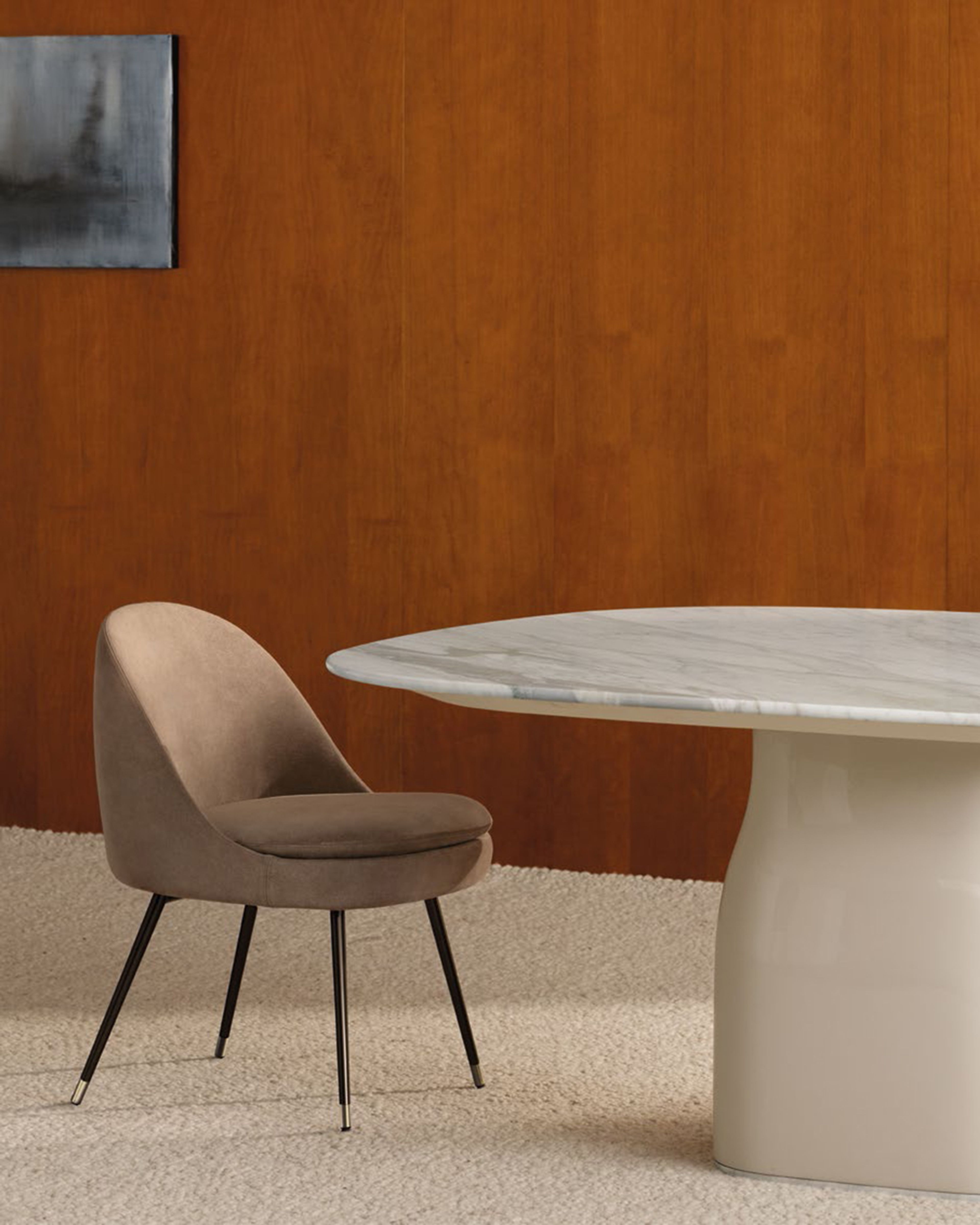 A sleek dining little armchair by Minotti.