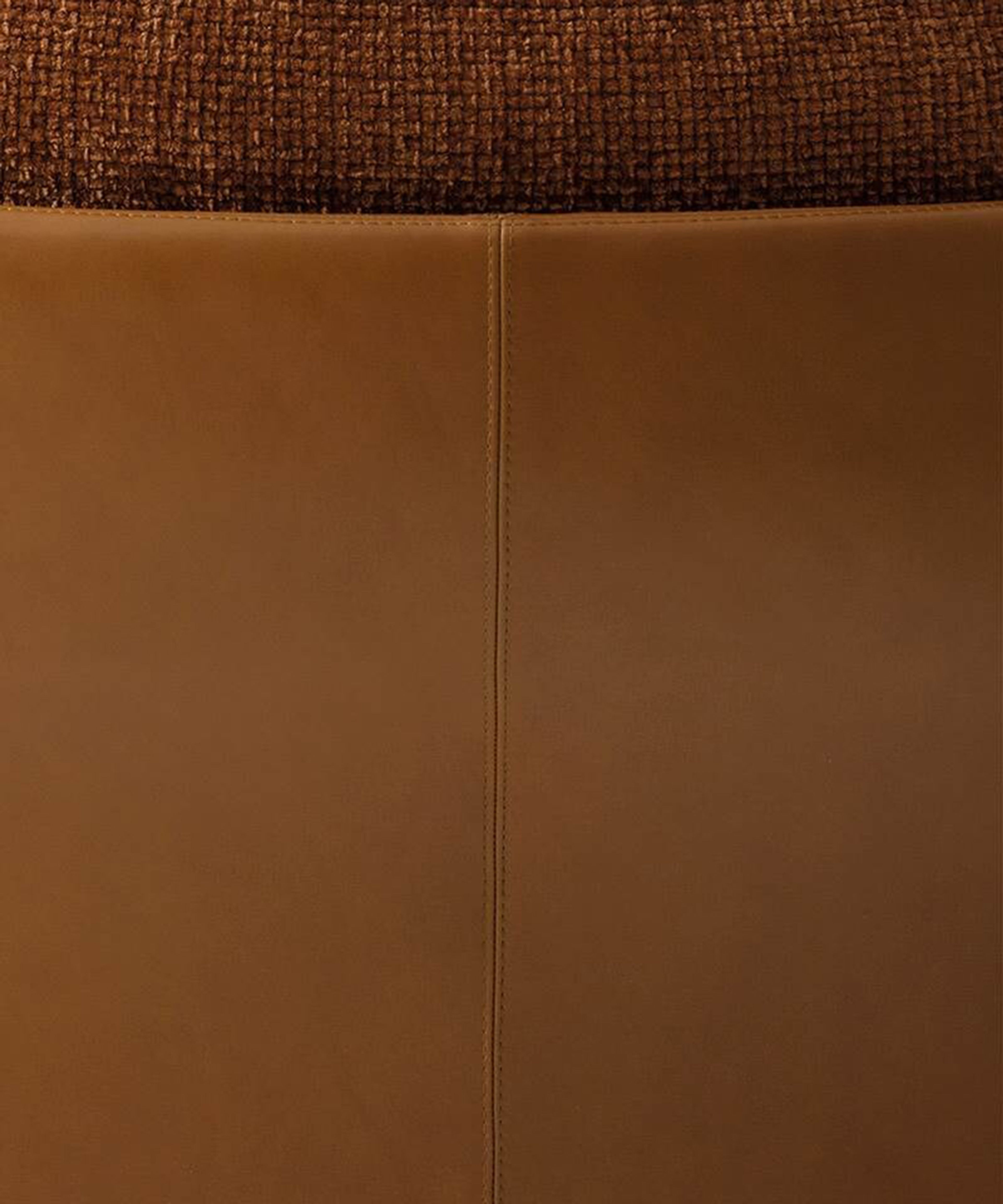 A sculptural armchair with enveloping organic forms by Minotti.