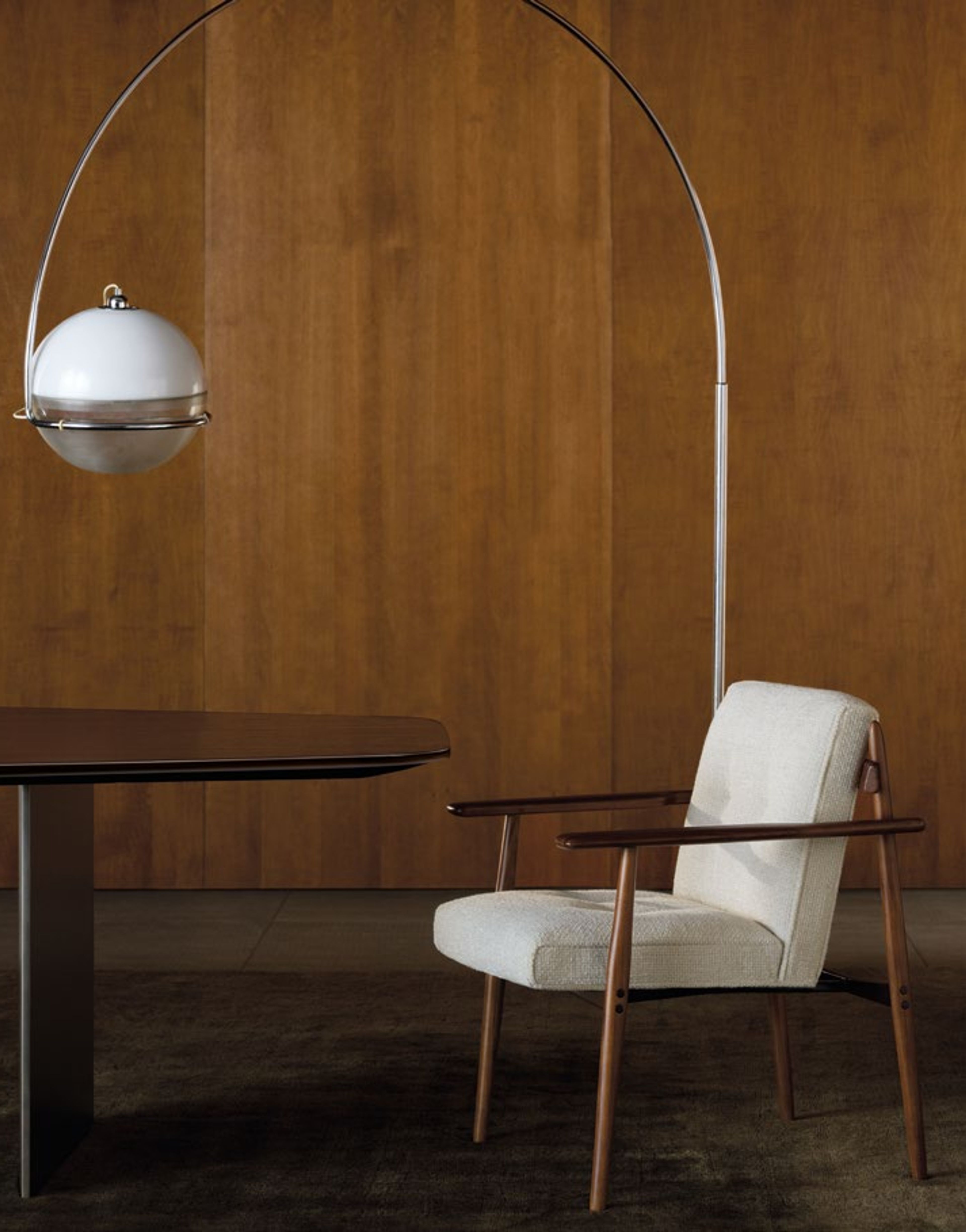 A sleek dining chair where leather, wood and metal come together.