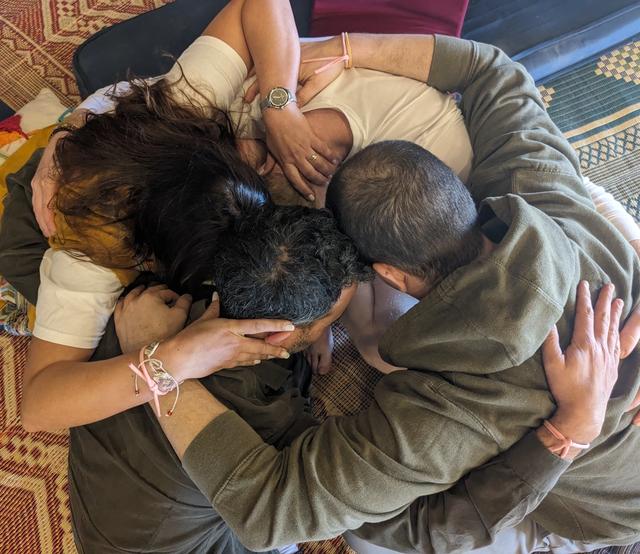 A group embracing in a close circle