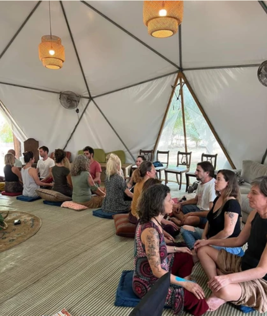 A group sitting together inside a geodesic dome