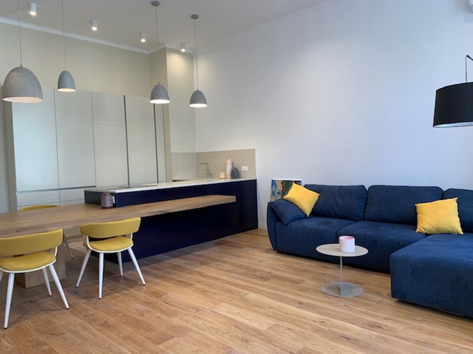 Living and dining area with blue sofa and wood floors, Kyiv — Vestor.Estate